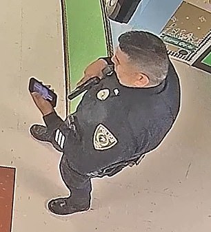 The police officer checks his phone while Salvador Ramos' rampage is ongoing. The officer's background image shows the pro-police symbol The Punisher