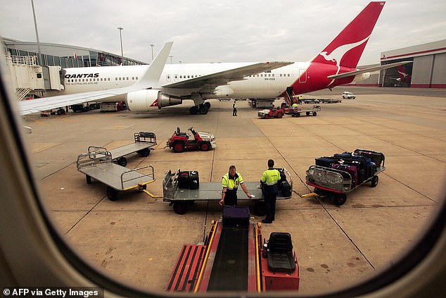 Qantas (pictured) said delays and cancellations of flights had been exacerbated by staff sick with the flu and Covid-19