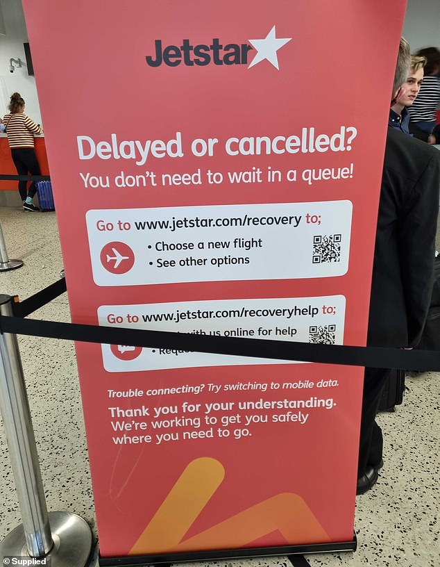 Passengers are urged to be mindful of delays and cancellations as staff shortages caused hour-long delays and cancellations (pictured, Jetstar flight rescheduling poster at Sydney Airport)