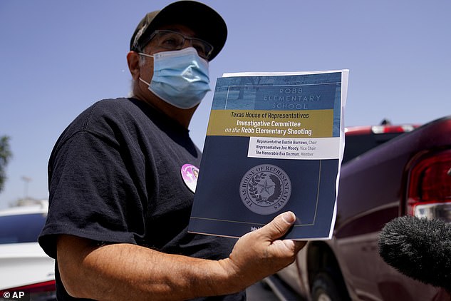 Vincent Salazar, grandfather of Layla Salazar who was killed in the school shooting at Robb Elementary, holds a report released by the Texas House investigative committee on the shootings at Robb Elementary School