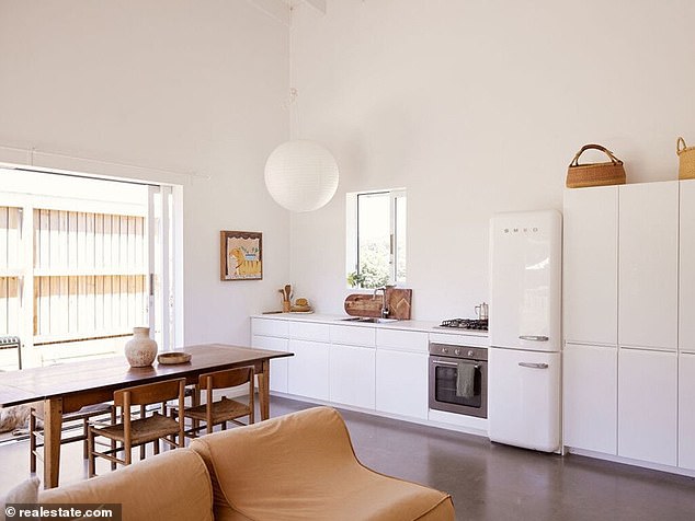 The two homes are both modern and minimalist in style, with the main house featuring three bedrooms and polished concrete floors