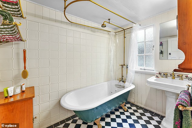 The home still has most of its original design, including a clawfoot bathtub with exposed pipes in one of the bathrooms (pictured)