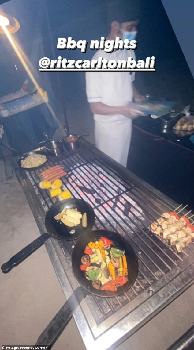 David hinted that his family were staying at the five-star resort earlier on Tuesday night when he shared a photo of a chef cooking skewers on a grill, captioned: 'Bbq nights @RitzCarltonBali'