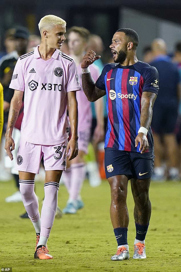 Pals: Romeo sported his light pink Beckham 37 jersey along with a matching pair of shorts as he chatted with Barcelona's Memphis Depay