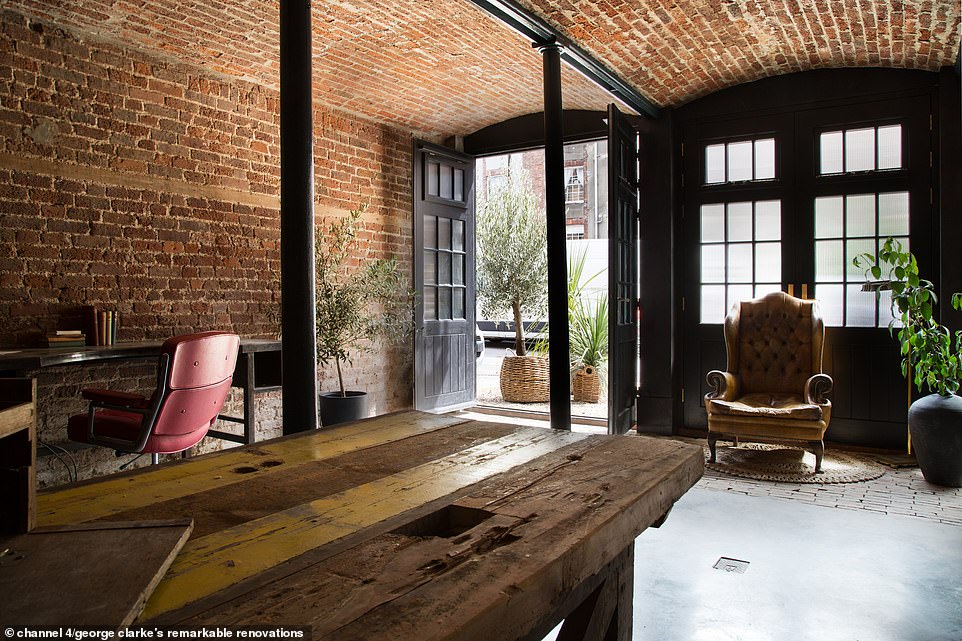 The bottom floor of the property had been transformed into a workshop studio, with James intent on reclaiming the old barn doors (pictured)