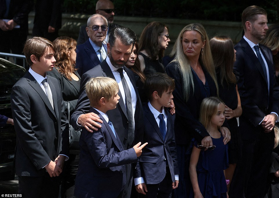 Donald Trump Jr. comforts two of his sons at the funeral of their grandmother Ivana on Wednesday