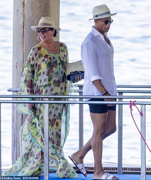 Looking good: Kris looked great in the pretty garment that was covered in red and white flowers and was teamed with sandals