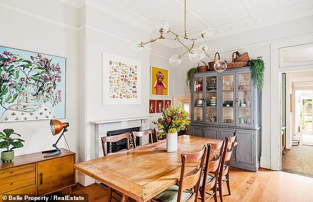 The historic home, known as Wavertree, has a style that blends Old World atmosphere with cosy charm. (Pictured: a dining area with a fireplace and vintage cabinetry)