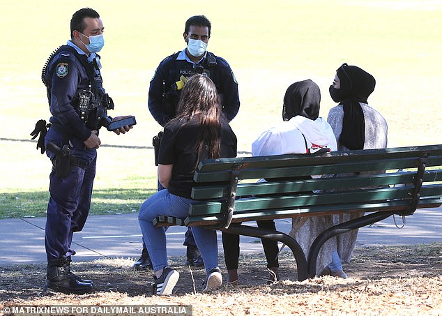 Revenue NSW data showed police handed out more Covid fines in August 2021 than they did in the previous 17 months combined (pictured, NSW Police handing out Covid infringement notices in Sydney in August 2021)