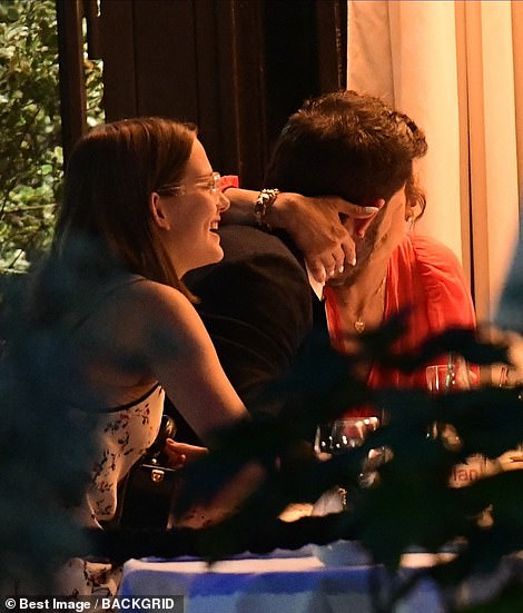 Intimate: Violet was seen laughing as the couple got cozy