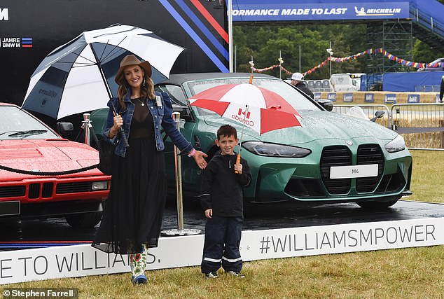 Doting mother: The pair were also joined by their six-year-old son Alfie, who was ready for the weather in a black ski jacket and layered trousers