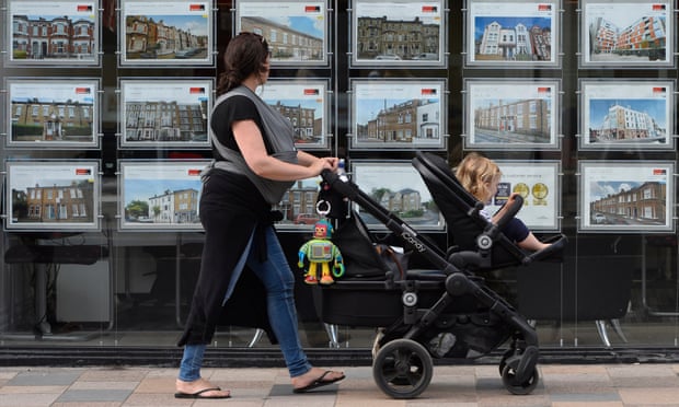 A woman looks at adverts in an estate agent window in south-west London in 2016