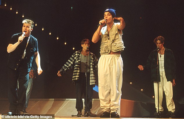 Iconic: Robbie rose to fame with Take That who formed in 1989 and went on to achieve 12 number one singles on the UK Singles Chart along with eight number one album (pictured 1994)