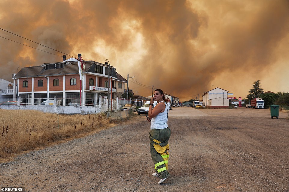 Firefighter from the Brigadas de Refuerzo en Incendios Forestales reacts as the fire reaches near Tabara, Zamora, in Spain