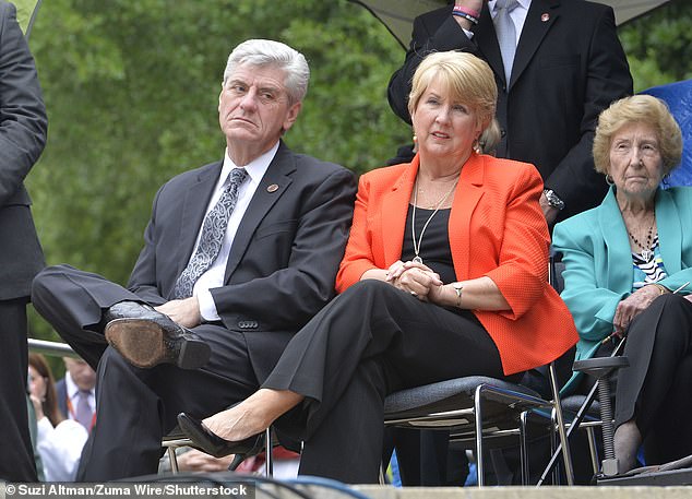 Former Mississippi Governor Phil Bryant, left, and his wife Deborah pictured in 2016. Deborah has been linked to an anti-corruption probe that reportedly saw a non-profit run by her friend Nancy New pony up $5 million in cash to build a volleyball center following a request from former NFL quarterback Brett Favre, after Favre pledged to donate the cash himself