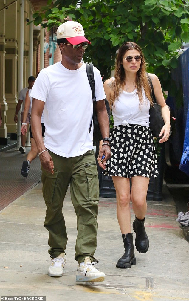 Chris' look: Rock stepped out wearing a white baseball cap with a red brim and dark sunglasses for the sunny afternoon outing