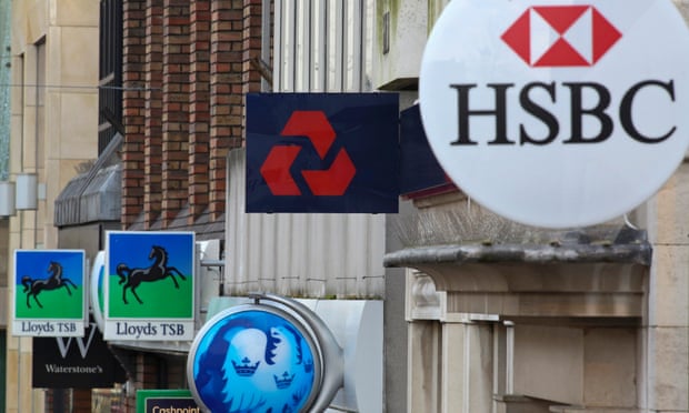 Signs sit outside branches of a Lloyds TSB, Barclays, NatWest and HSBC