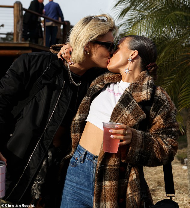 The couple, who have been dating for over a year, couldn't keep their hands off each other as they posed for photographers