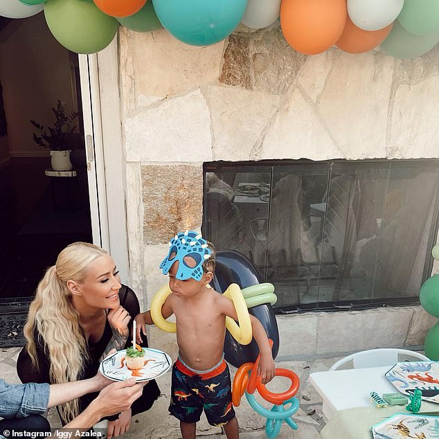 One photo showed the doting mum-of-one crouching down alongside her son as he blew out the candle on his birthday cupcake at the May party