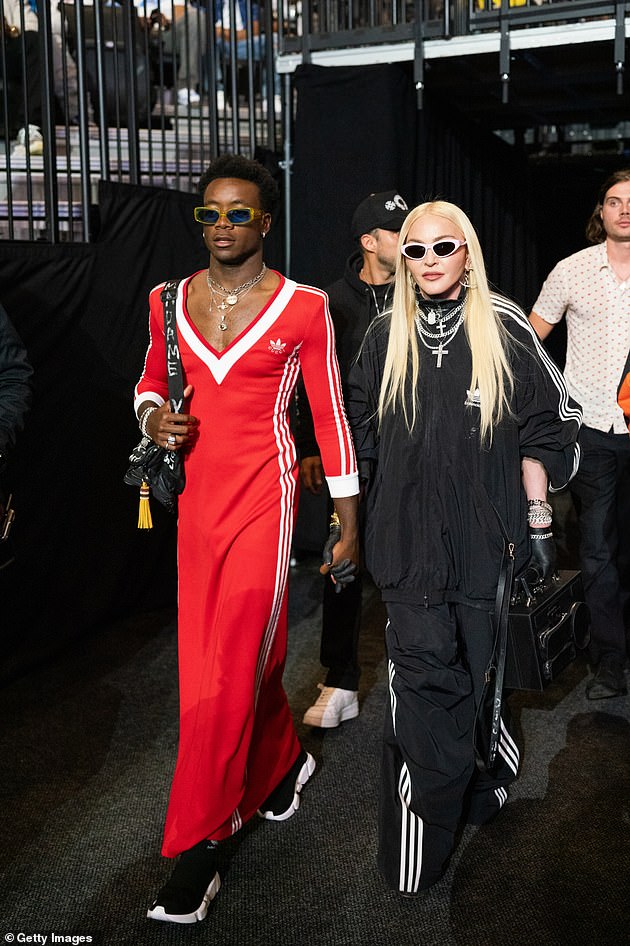 Fashionable: David showed off his expert sense of style in an eye-catching red t-shirt dress from the highly-anticipated Adidas x Gucci collection in Brooklyn back in June