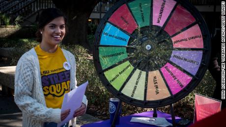 A Louisiana State University Street Squad peer educator shares information about safe sex practices with fellow students. 