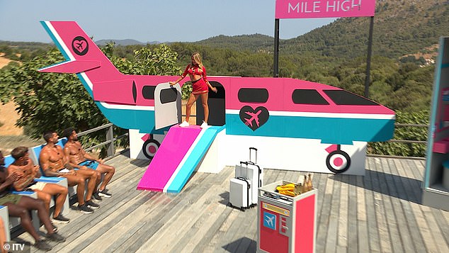 The boys lined up in airplane seats as the girls each emerged from the plane for the playful challenge