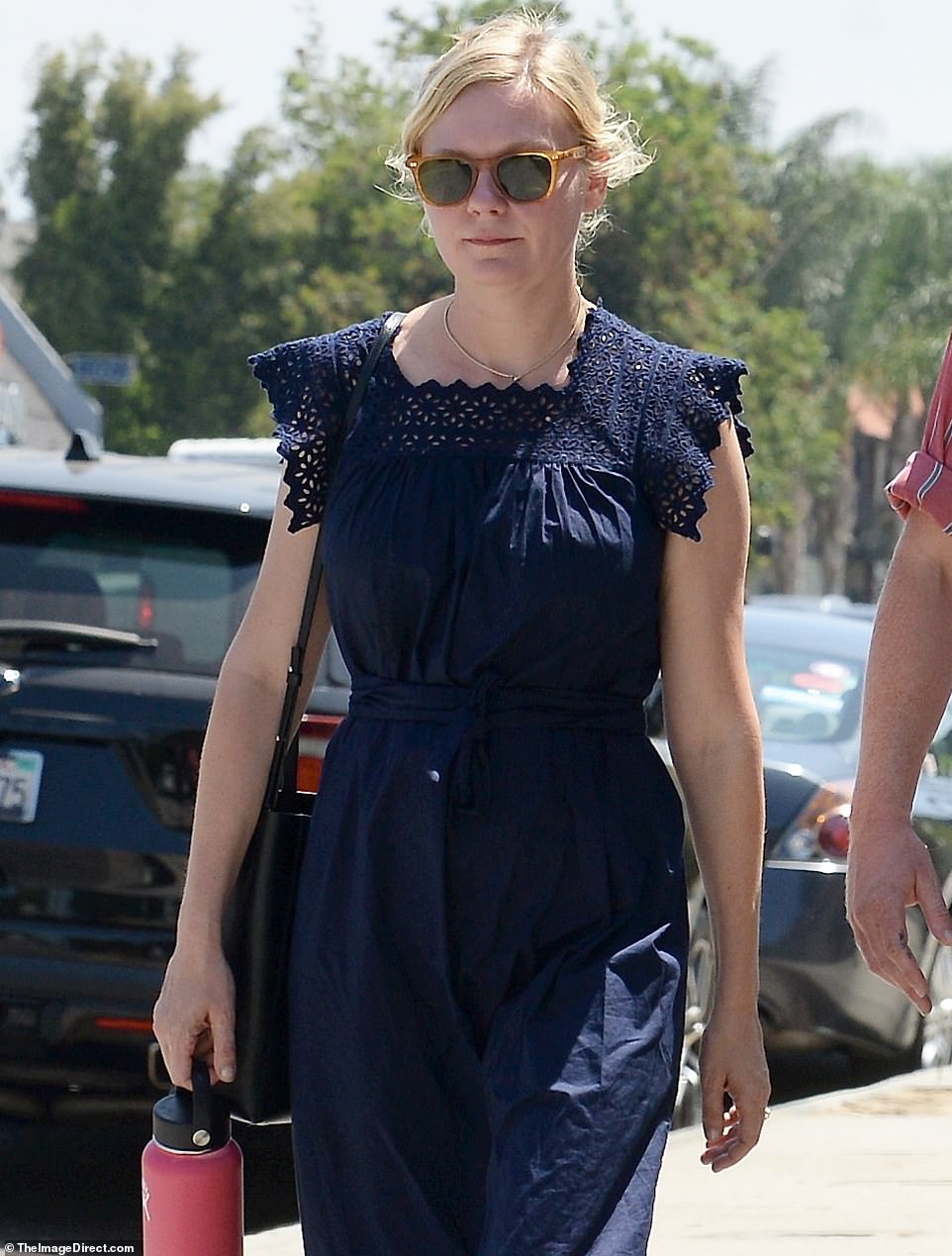 The look: The blonde beauty pulled her hair back as she wore light brown framed sunglasses with dark green lenses. Jesse was fashionable in a strawberry pink shirt with blue and white striped. The pockets showed the pattern to the side. He added dark slacks and blue Converse high top sneakers as he flashed a black bang watch and had on dark sunglasses.