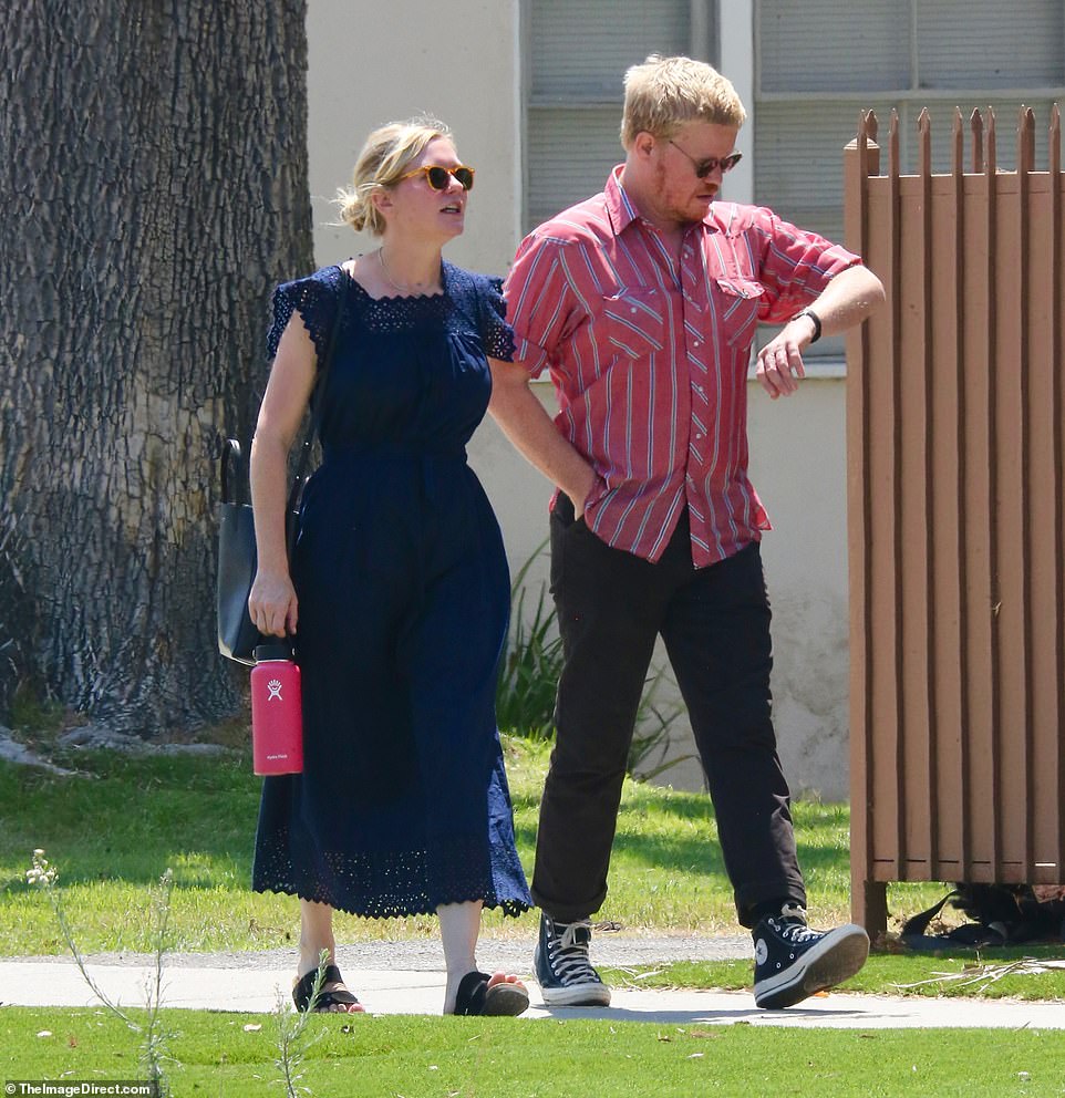 Time to walk faster: Plemons took a look at his wrist watch as he kept one hand in his pocket