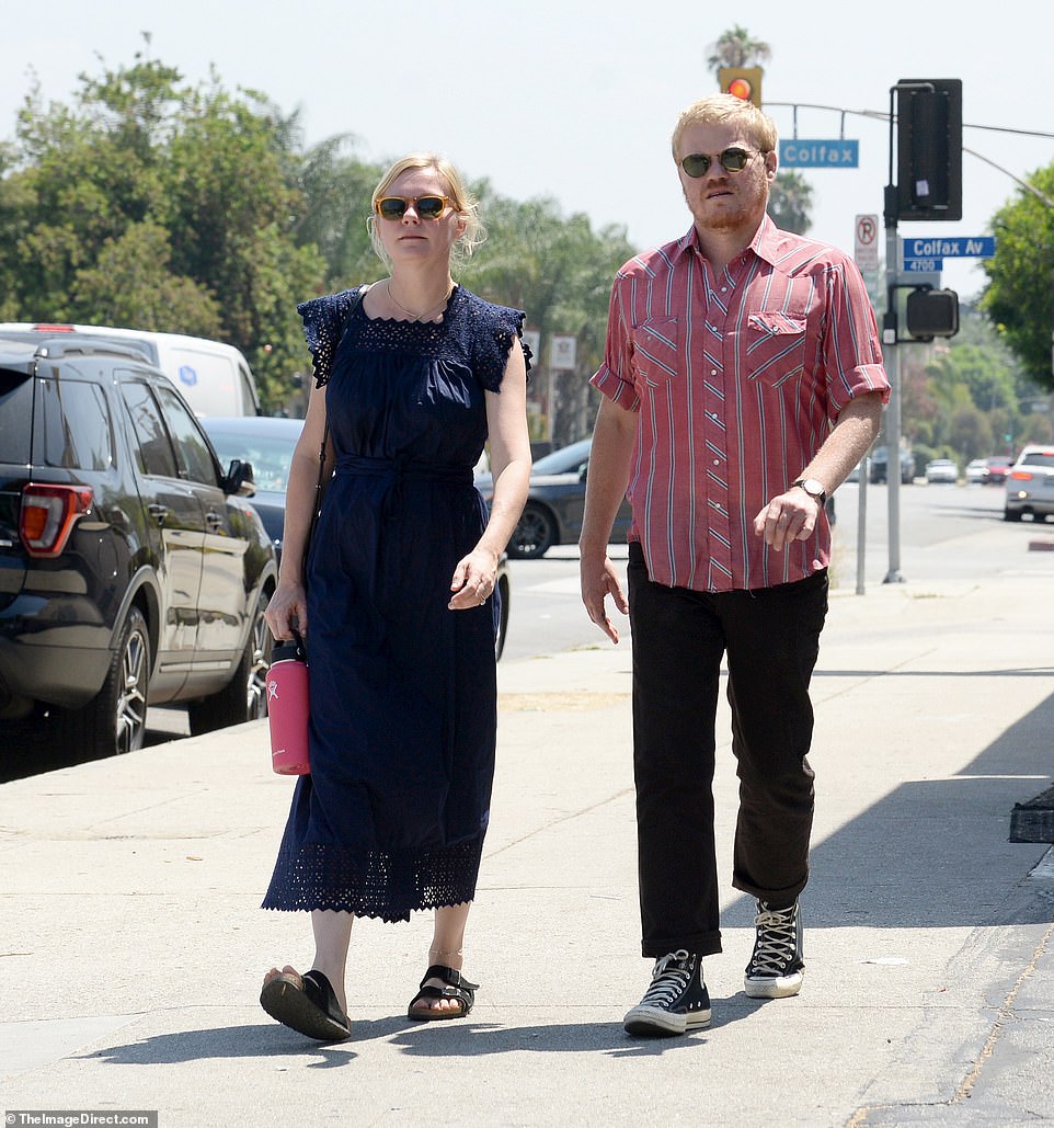 Dressed for the heat: Dunst looked feminine in a dark blue summer dress with lace on the neckline, sleeves and hemline