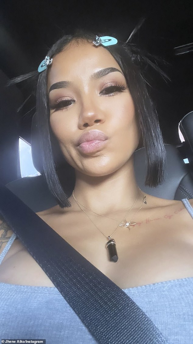 Cute: Aiko snapped an up-close selfie while buckled into a vehicle with a black leather interior