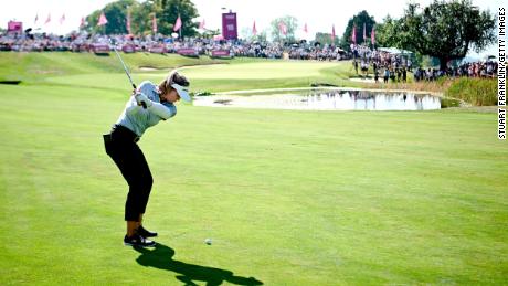 Henderson plays her second shot at the 18th hole.