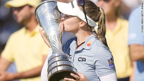 Henderson kisses the victor&#39;s trophy.