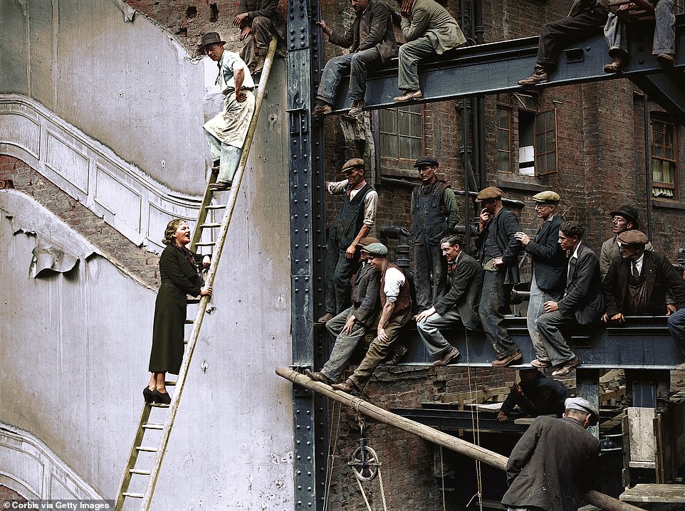 Gracie Fields, who was then the highest-paid film star in the world, is seen above singing to builders after laying the foundation stone for the new Prince of Wales Theatre on Coventry Street in London's West End in June 1937