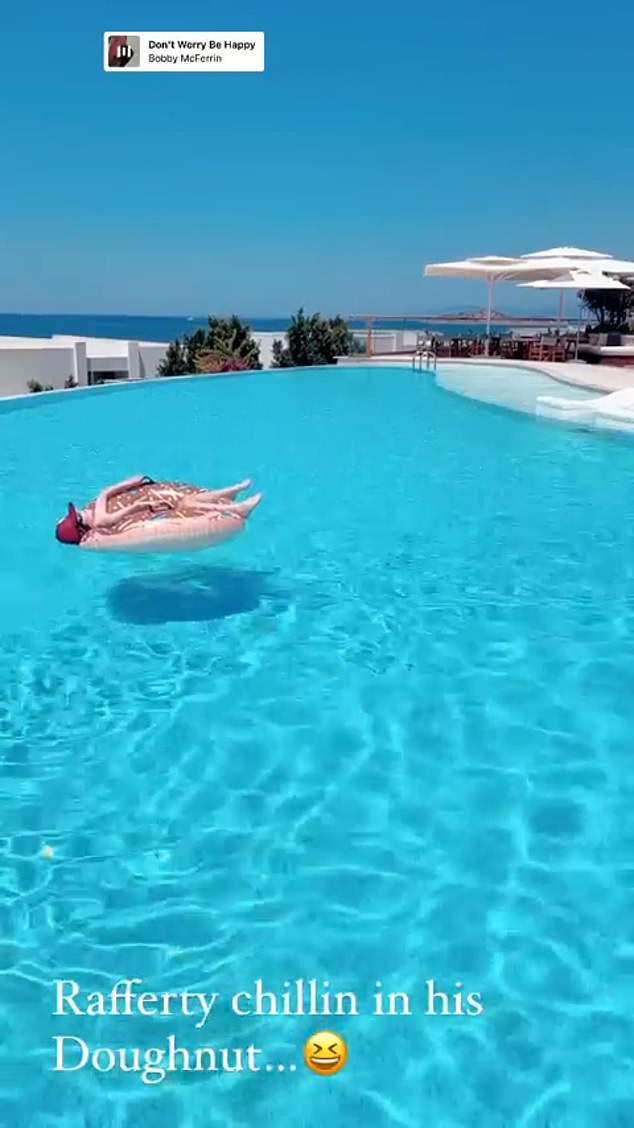 Cool: Later in the day, the mother-of-one uploaded clip of her only son coasting along in the pool chilling in a swing ring