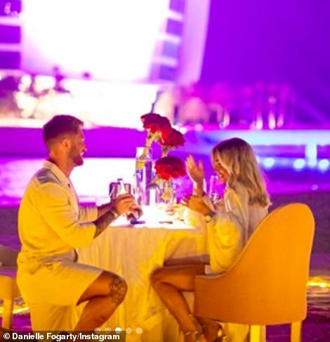 Wow! In another cute snap from the announcement, the loved-up pair dined al fresco on the beach in front of the illuminated Burj Al Arab luxury hotel