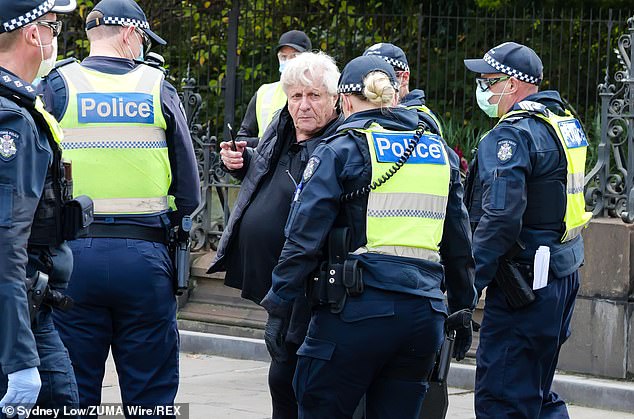 Solihin Millin is moved on by police in Melbourne during a stage-4 lockdown for leaving home without a legitimate reason in August 2020