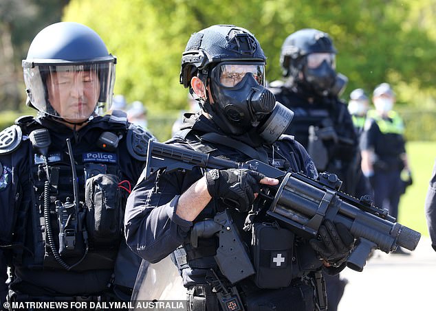 Lest we forget: A policeman keeps the peace outside the Shrine of Remembrance