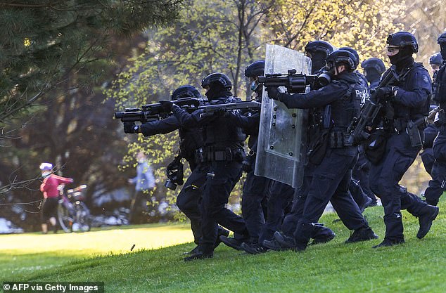 Police fire tear gas towards protesters in the gardens surrounding the Shrine of Remembrance in September last year