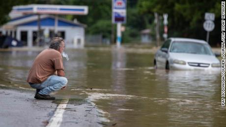 Van Jackson checks on his dog, Jack, who was stranded at a church by flood waters along Right Beaver Creek in Garrett, Kentucky, on Thursday.