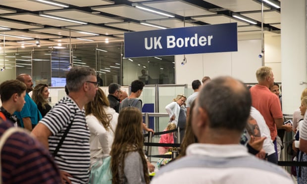 People queuing at the UK border immigration control