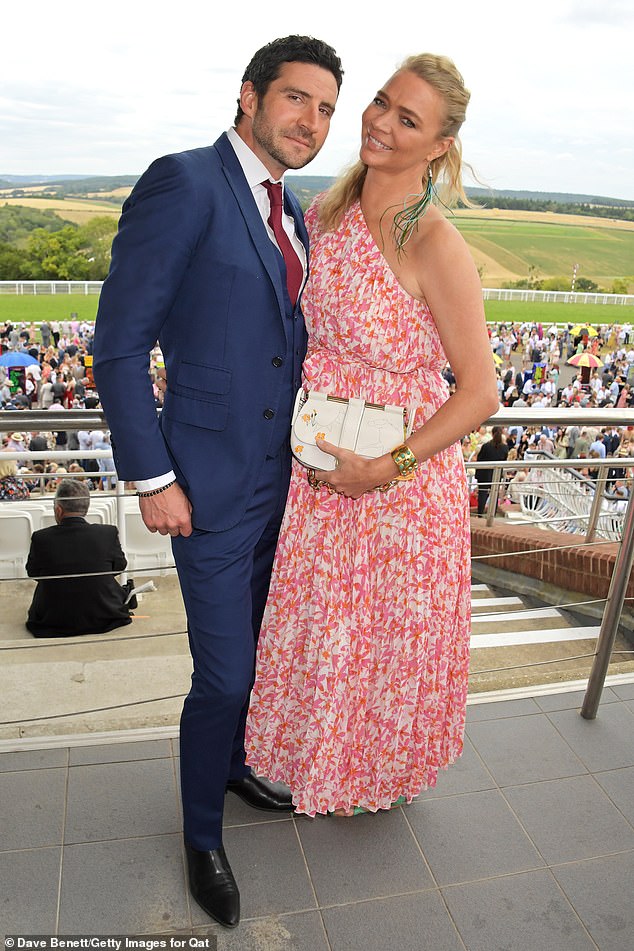 Race ready: The model, 43, nailed a summer chic look in a breezy floral print dress that featured pink and orange accents