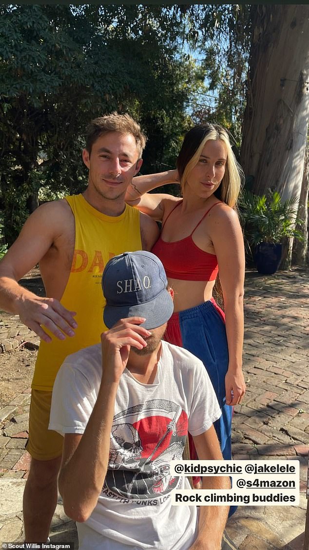 Relaxing with friends: Another snap saw her posing outside with two guy friends, and looking athletic in a red crop top and blue and red sweatpants