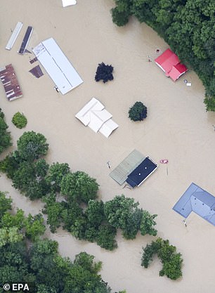 Floodwaters reached up to the roofs of buildings in Kentucky