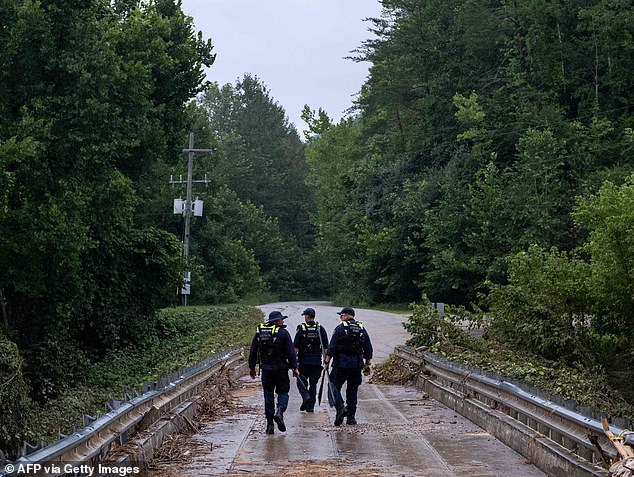 A search and rescue team in Jackson County, Kentucky, look for victims and survivors of the region's flooding