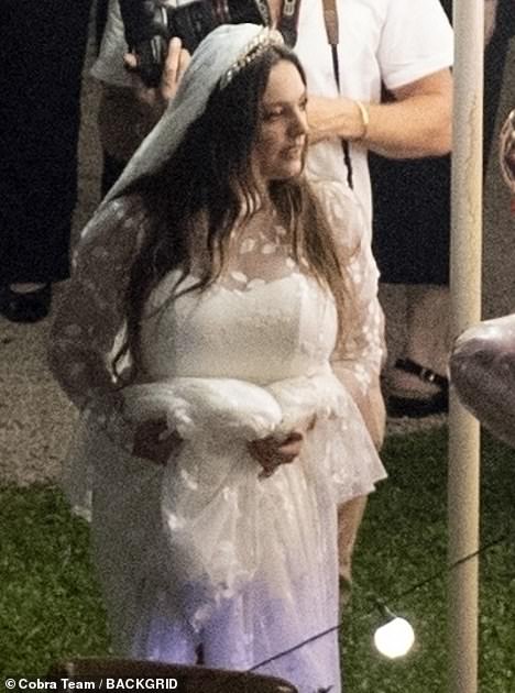 Lovely: Kelly, 42, looked stunning in a traditional ivory white bridal gown with sheer lace detail on her wedding day