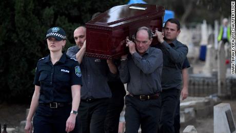 Adelaide Cemetery Authority pall bearers carry the body of the exhumed Somerton man, May 19, 2021.