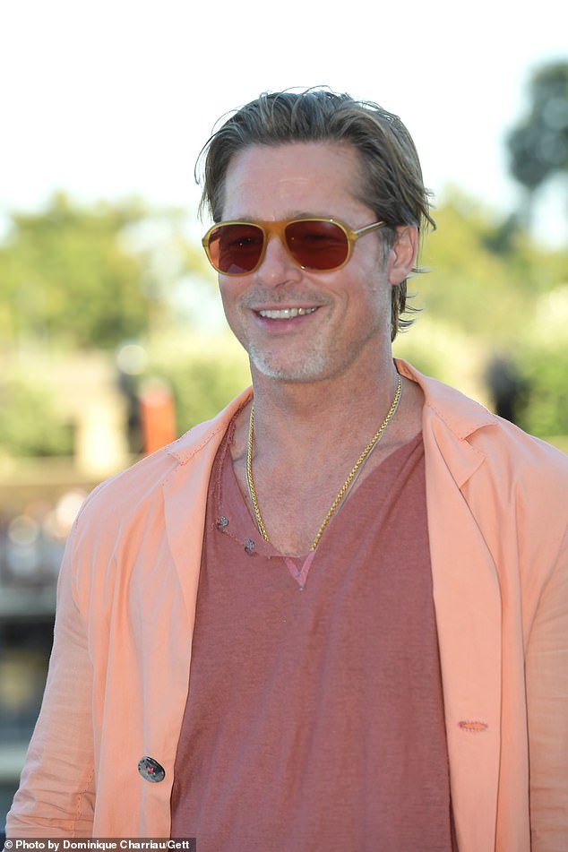 Brad Pitt puts on an eye-catching display in an orange blazer at the Bullet Train photocall in Paris