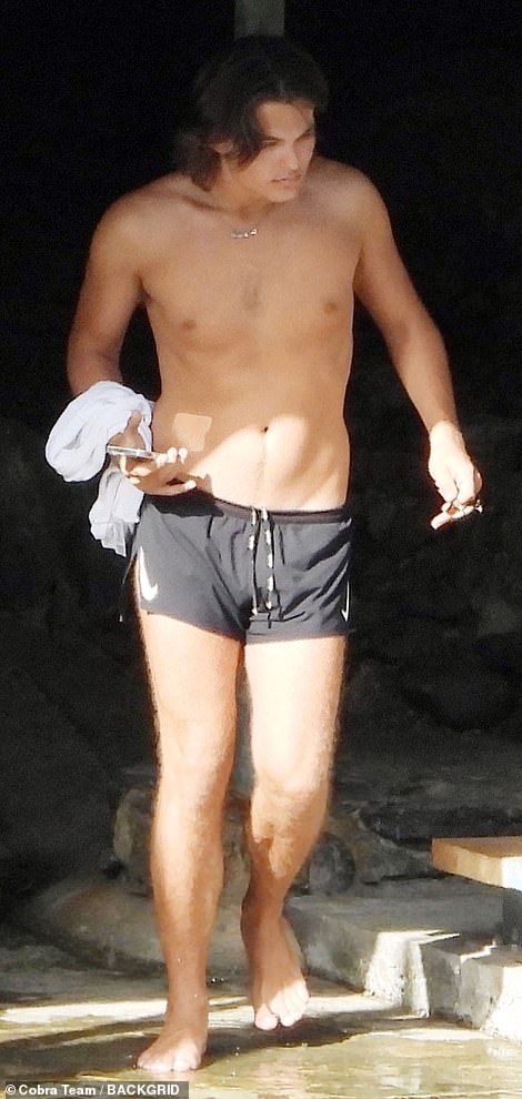 Damian Hurley, 20, is surrounded by female friends as he tops up his tan Liz in Portofino