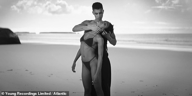 FKA twigs writhes around on the beach with her male co-star in steamy Killer music video 