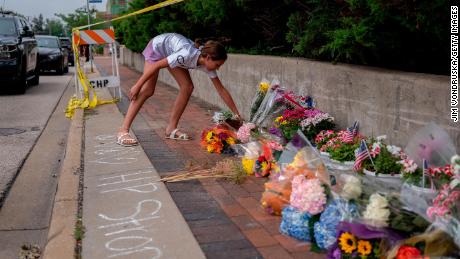 A mourner visits a memorial for the victims of a mass shooting at a Fourth of July parade, on Wednesday in Highland Park, Illinois. 